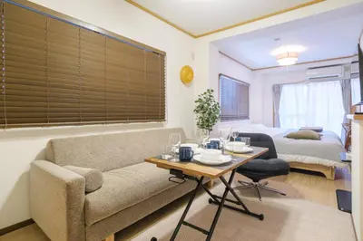 a living room with a couch and a table at Cozy Nest Sangenjaya 1 Stop to Shibuya \u30fcWalk to Sangenjaya and Ikejiri in Tokyo