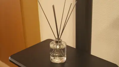 a glass vase with sticks in it on a table at Cozy Nest Sangenjaya 1 Stop to Shibuya \u30fcWalk to Sangenjaya and Ikejiri in Tokyo