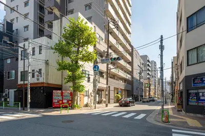 an empty street in a city with buildings at \u53f0\u67713\u4e01\u76ee\u6238\u5efa in Tokyo