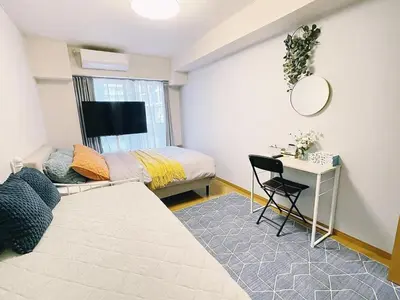 a bedroom with a bed and a desk with a mirror at sitamachi Shin-Koiwa 302 in Tokyo