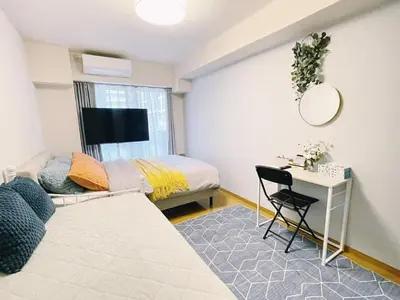 a bedroom with a bed and a desk with a mirror at sitamachi Shin-Koiwa 302 in Tokyo
