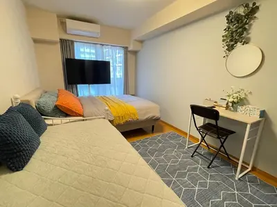 a bedroom with a bed and a table and a desk at sitamachi Shin-Koiwa 302 in Tokyo