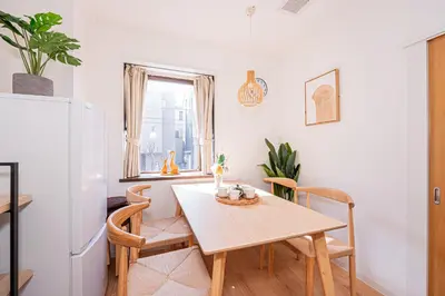 a kitchen and dining room with a table and a refrigerator at Akabanestay A \u5fd7\u8302 in Tokyo