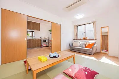 a living room with a table and a couch at Akabanestay A \u5fd7\u8302 in Tokyo