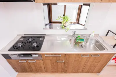 a kitchen with a sink and a stove at Akabanestay A \u5fd7\u8302 in Tokyo