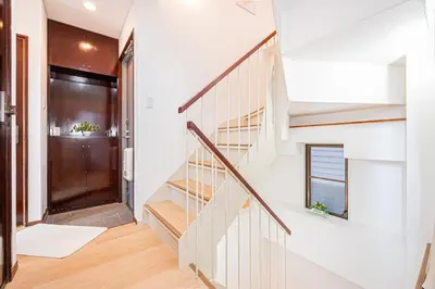 a staircase in a home with white walls and wooden floors at Akabanestay A \u5fd7\u8302 in Tokyo