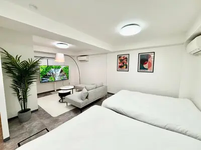 a bedroom with two beds and a living room at R101-Shinjuku 13 minUp to 8 people 60 sqmFull renovationRoppongi and Tsukiji direct accessFamily group7 min to Ochiai Minami-Nagasaki Station in Tokyo
