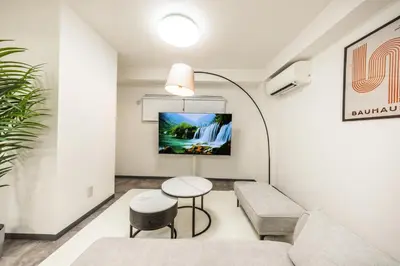 a living room with a couch and a table at R101-Shinjuku 13 minUp to 8 people 60 sqmFull renovationRoppongi and Tsukiji direct accessFamily group7 min to Ochiai Minami-Nagasaki Station in Tokyo
