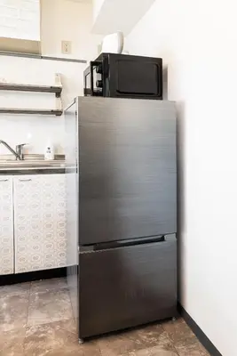 a refrigerator with a tv on top of it in a kitchen at R101-Shinjuku 13 minUp to 8 people 60 sqmFull renovationRoppongi and Tsukiji direct accessFamily group7 min to Ochiai Minami-Nagasaki Station in Tokyo