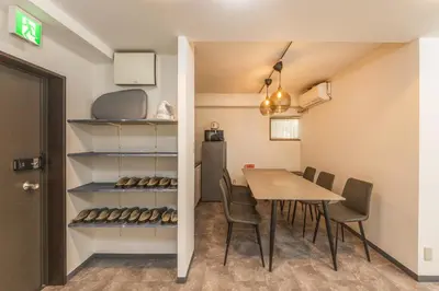 a dining room with a table and chairs and a refrigerator at R101-Shinjuku 13 minUp to 8 people 60 sqmFull renovationRoppongi and Tsukiji direct accessFamily group7 min to Ochiai Minami-Nagasaki Station in Tokyo