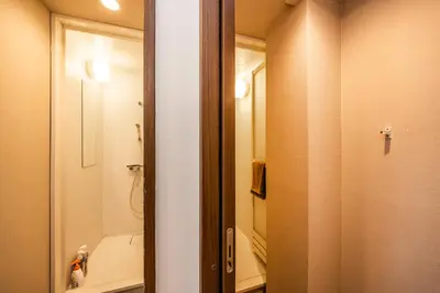a bathroom with a shower and a toilet and a mirror at R101-Shinjuku 13 minUp to 8 people 60 sqmFull renovationRoppongi and Tsukiji direct accessFamily group7 min to Ochiai Minami-Nagasaki Station in Tokyo