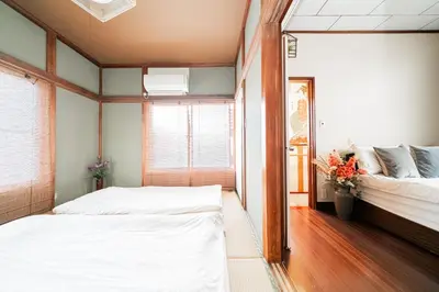 a bedroom with two beds and a window at Japanese Traditional Villa 8ppl 5min to ST in Tokyo