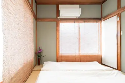 a small bedroom with a bed and a window at Japanese Traditional Villa 8ppl 5min to ST in Tokyo