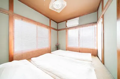 a bedroom with two beds and two windows at Japanese Traditional Villa 8ppl 5min to ST in Tokyo