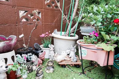 a group of figurines in a garden with potted plants at Japanese Traditional Villa 8ppl 5min to ST in Tokyo