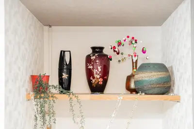 a shelf with vases and plants on it at Japanese Traditional Villa 8ppl 5min to ST in Tokyo
