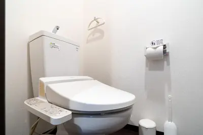 a small bathroom with a white toilet in a stall at Maison Miyashita in Tokyo