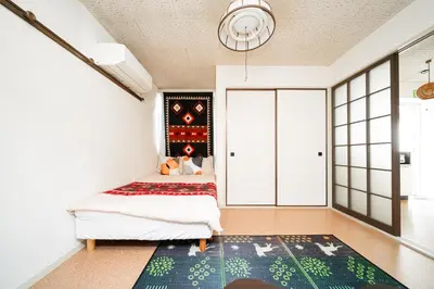 a bedroom with a bed and a rug at 2 min walk to Komagome ST 4ppl superior apart in Tokyo