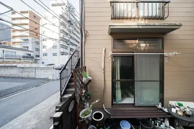 a balcony of a house with a window and plants at 2 min walk to Komagome ST 4ppl superior apart in Tokyo
