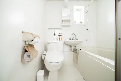a white bathroom with a toilet and a sink at 2 min walk to Komagome ST 4ppl superior apart in Tokyo