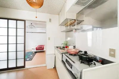 a kitchen with a stove with a pot on it at 2 min walk to Komagome ST 4ppl superior apart in Tokyo