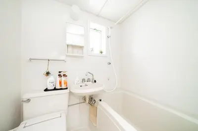 a white bathroom with a tub and a sink at 2 min walk to Komagome ST 4ppl superior apart in Tokyo