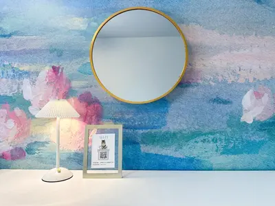 a mirror on a wall next to a lamp and a picture at Hotel Ikebukuro Fine Coat in Tokyo