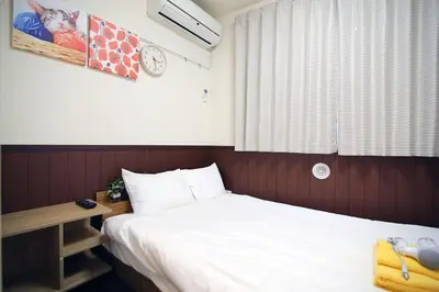 a hotel room with a bed and a desk and a window at Central Shinjuku, Near Train Station, Quiet Area, No Stairs, Room 102 in Tokyo