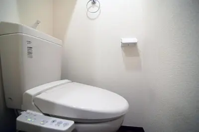 a bathroom with a white toilet with a remote control at Central Shinjuku, Near Train Station, Quiet Area, No Stairs, Room 102 in Tokyo