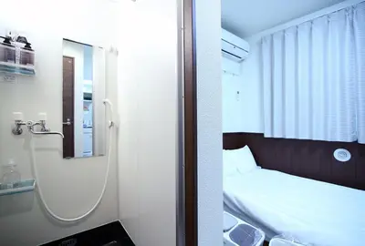 a bedroom with a bed with a mirror and a mirror at Central Shinjuku, Near Train Station, Quiet Area, No Stairs, Room 102 in Tokyo
