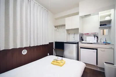 a small kitchen with a bed in a room at Central Shinjuku, Near Train Station, Quiet Area, No Stairs, Room 102 in Tokyo