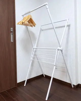 a white towel rack next to a wall at ohayo\u4e21\u56fd in Tokyo