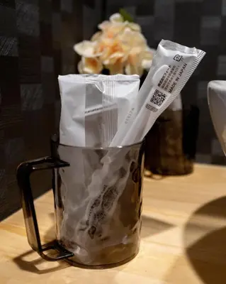 a cup with two utensils in it on a table at ohayo\u4e21\u56fd in Tokyo
