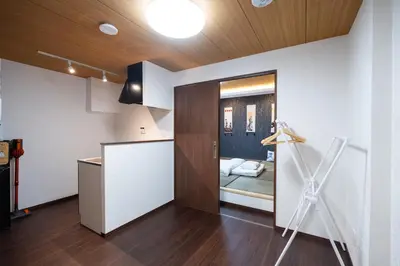 a room with a kitchen with a door to a bedroom at ohayo\u4e21\u56fd in Tokyo