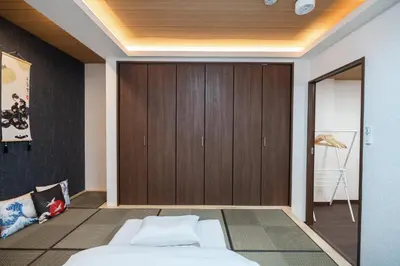 a bedroom with two beds and a closet at ohayo\u4e21\u56fd in Tokyo