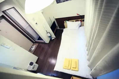 a view of a bedroom with a bed with a yellow mattress at Quiet Area, Close to Station, Central Shinjuku, Room 202 in Tokyo