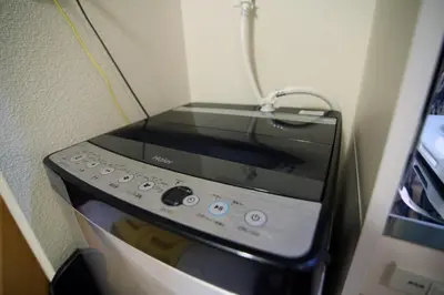 a microwave oven in a corner of a kitchen at Quiet Area, Close to Station, Central Shinjuku, Room 202 in Tokyo