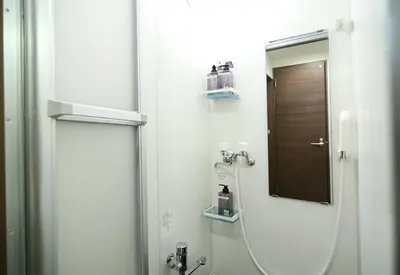 a bathroom with a shower with a mirror and a sink at Quiet Area, Close to Station, Central Shinjuku, Room 202 in Tokyo