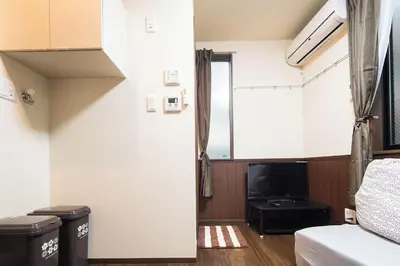 a living room with a bed and a tv at Central Shinjuku, Quiet Area, Close to Station, No Stairs, Room101 in Tokyo