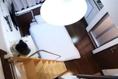 an overhead view of a room with a bed and a lamp at Close to Station, Quiet Area, Central Shinjuku, Room 203 in Tokyo