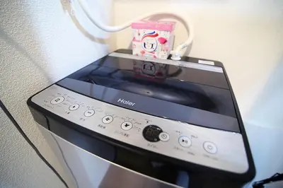 a tablet computer sitting on top of a microwave at Close to Station, Quiet Area, Central Shinjuku, Room 203 in Tokyo