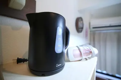 a black appliance sitting on top of a counter at Close to Station, Quiet Area, Central Shinjuku, Room 203 in Tokyo