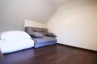a living room with a couch and a ottoman at Close to Station, Quiet Area, Central Shinjuku, Room 203 in Tokyo