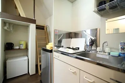 a small kitchen with a sink and a refrigerator at Central Shinjuku, Quiet Area, Close to Station, Room205 in Tokyo