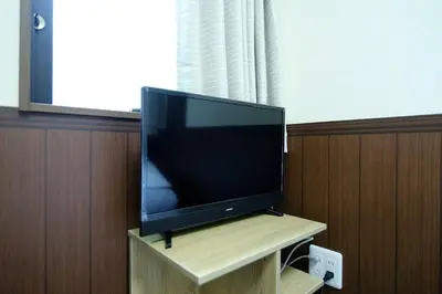 a flat screen tv sitting on top of a wooden stand at Central Shinjuku, Quiet Area, Close to Station, Room205 in Tokyo