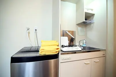 a small kitchen with a stove and a sink at Central Shinjuku, Quiet Area, Close to Station, Room205 in Tokyo