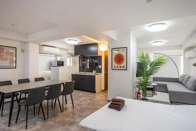 a living room and kitchen with a table and chairs at R201-Shinjuku 13 min Up to 8 people 60 sqm Full renovation Roppongi and Tsukiji direct access Family group 7 min to Ochiai Minami Nagasaki Station in Tokyo