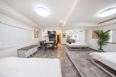 a room with two beds and a table in it at R201-Shinjuku 13 min Up to 8 people 60 sqm Full renovation Roppongi and Tsukiji direct access Family group 7 min to Ochiai Minami Nagasaki Station in Tokyo