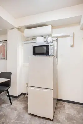 a kitchen with a microwave on top of a refrigerator at R201-Shinjuku 13 min Up to 8 people 60 sqm Full renovation Roppongi and Tsukiji direct access Family group 7 min to Ochiai Minami Nagasaki Station in Tokyo
