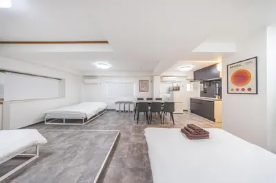 a room with two beds and a table in it at R201-Shinjuku 13 min Up to 8 people 60 sqm Full renovation Roppongi and Tsukiji direct access Family group 7 min to Ochiai Minami Nagasaki Station in Tokyo